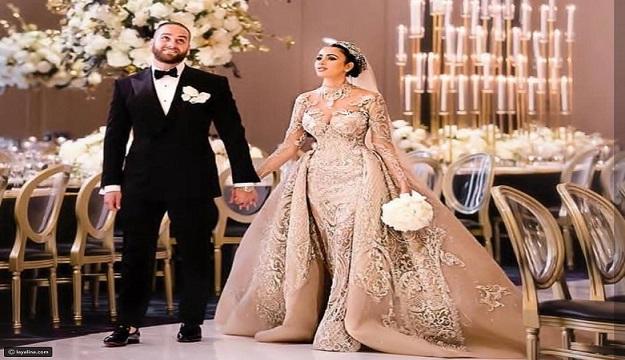 بالصور.. عروس لبنانية تخطف الأنفاس بفستان زفاف ذهبي من تصميم ستيفن خليل